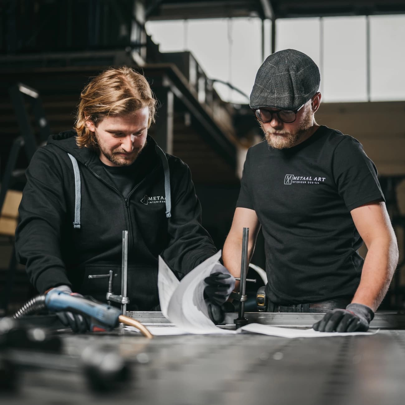 Mannen bezig met het maken van een stalen vloerluik